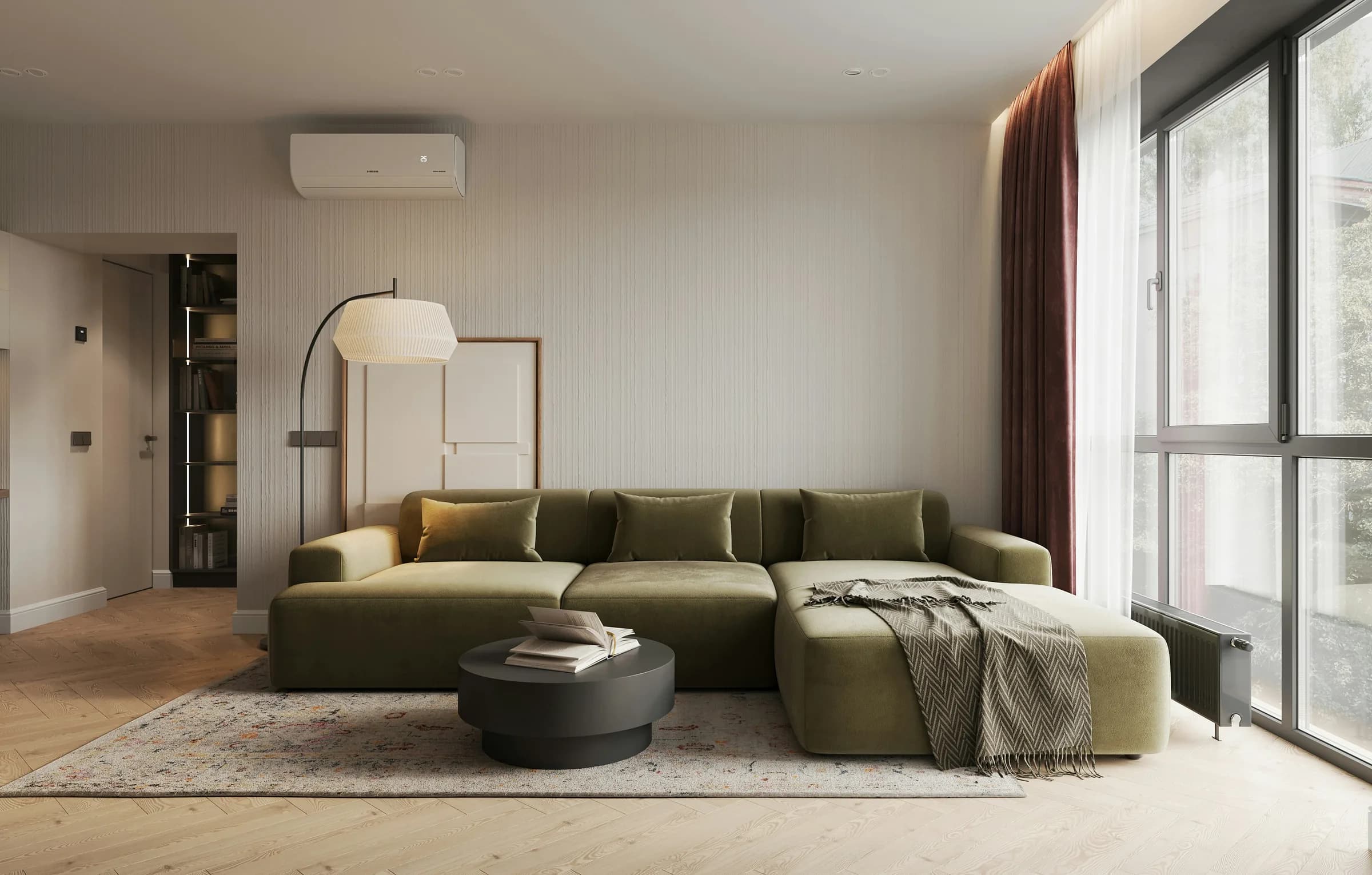 Séjour lumineux d'un appartement géré par Naya : canapé d'angle vert, lampadaire et grande baie vitrée